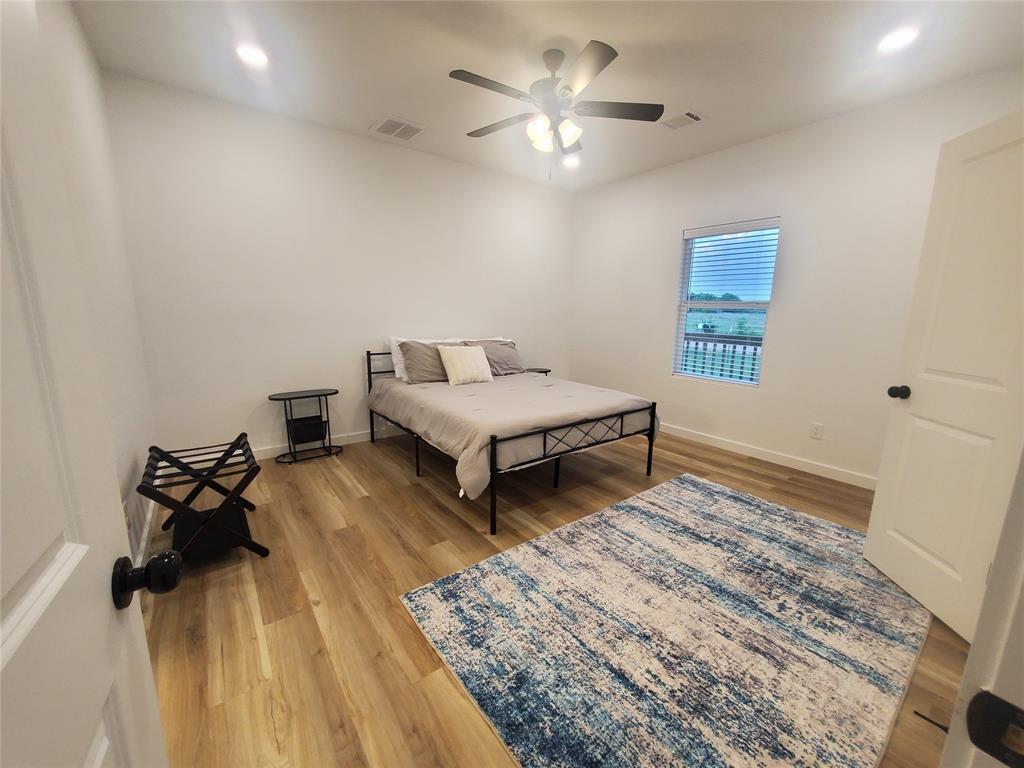 105 Red Tip Lane Brenham, TX 77833 - Photo 38 of 40 a living room with a bed furniture and a chandelier