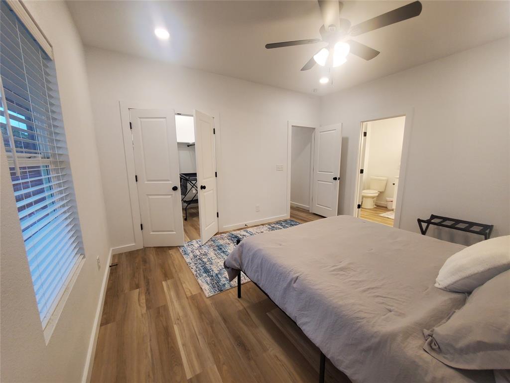 105 Red Tip Lane Brenham, TX 77833 - Photo 39 of 40 a bedroom with a bed and a chandelier