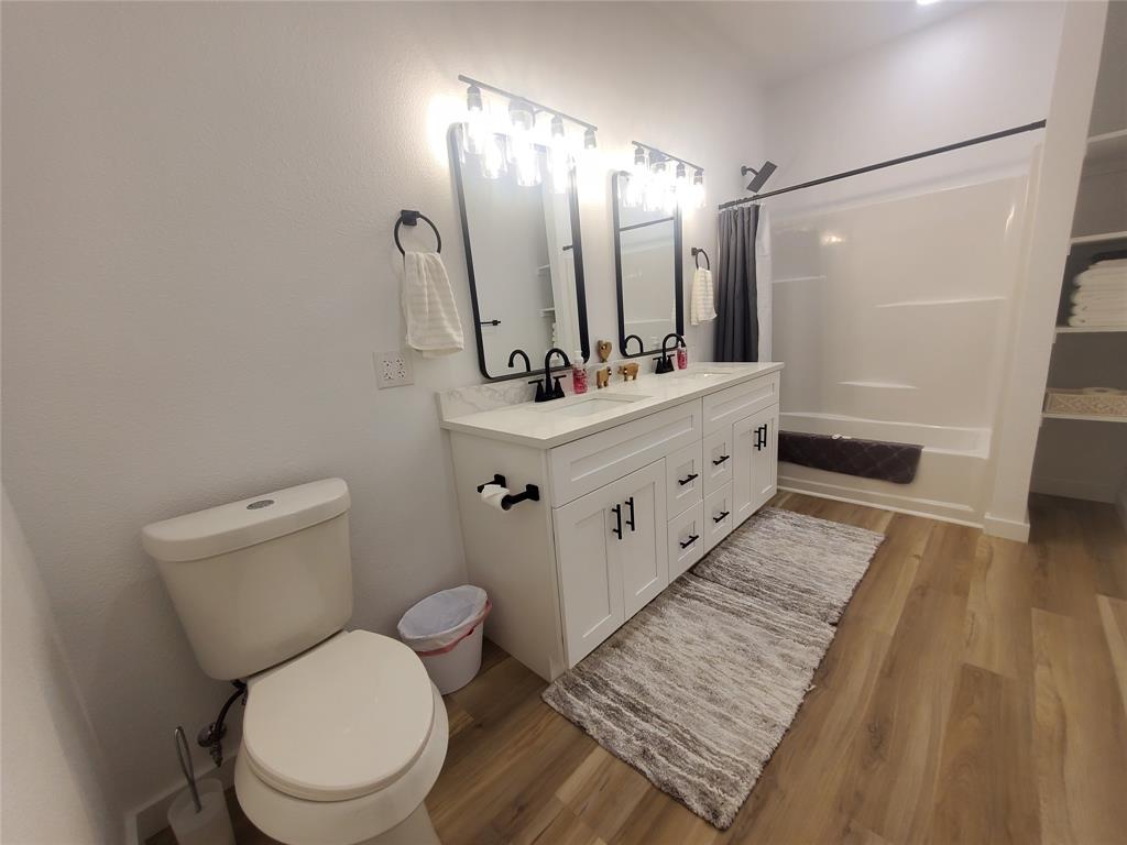 105 Red Tip Lane Brenham, TX 77833 - Photo 40 of 40 a bathroom with a sink a toilet a mirror and shower