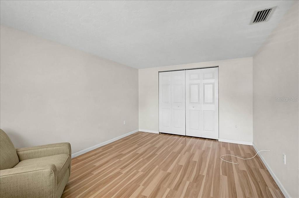 4514 South Lockwood Ridge Road Sarasota, FL 34231 - Photo 13 of 35 a view of empty room with wooden floor