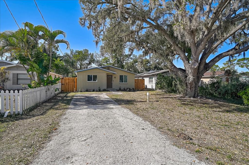 4514 South Lockwood Ridge Road Sarasota, FL 34231 - Photo 34 of 35 a view of a house with a tree in the yard