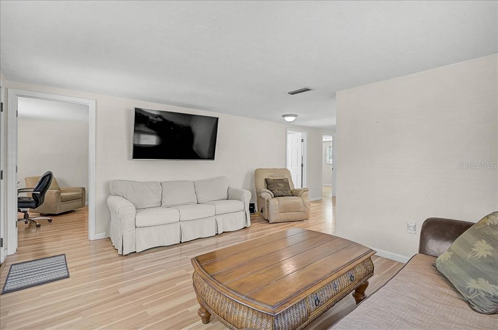 4514 South Lockwood Ridge Road Sarasota, FL 34231 - Photo 6 of 35 a living room with furniture and a flat screen tv