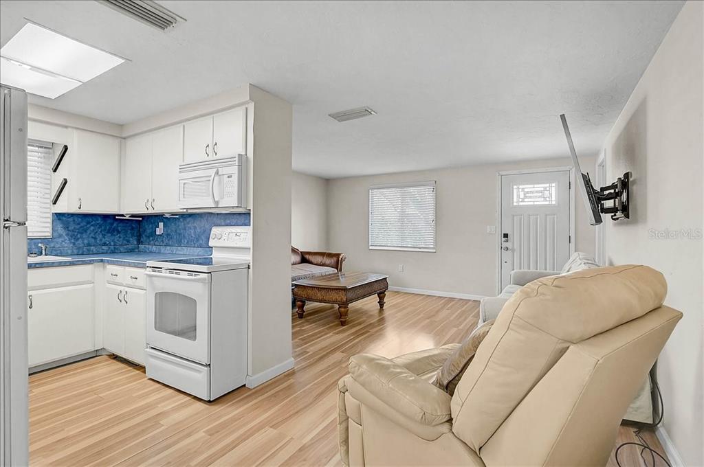 4514 South Lockwood Ridge Road Sarasota, FL 34231 - Photo 8 of 35 a kitchen with stainless steel appliances granite countertop a stove a sink and a refrigerator