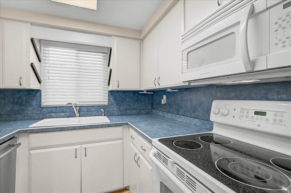 4514 South Lockwood Ridge Road Sarasota, FL 34231 - Photo 10 of 35 a kitchen with a sink cabinets and window
