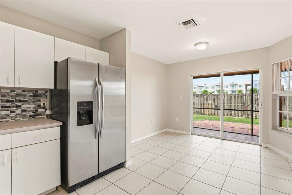 15313 Southwest 138th Terrace Miami, FL 33196 - Photo 12 of 44 a kitchen with a refrigerator a stove top oven and a large window