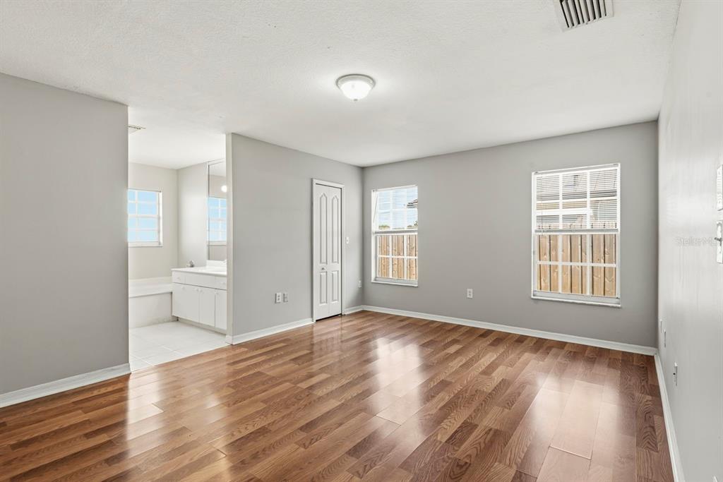 15313 Southwest 138th Terrace Miami, FL 33196 - Photo 20 of 44 a view of an empty room with wooden floor and a window