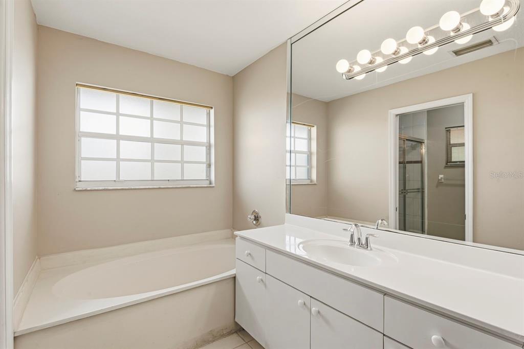 15313 Southwest 138th Terrace Miami, FL 33196 - Photo 23 of 44 a bathroom with a tub sink and mirror