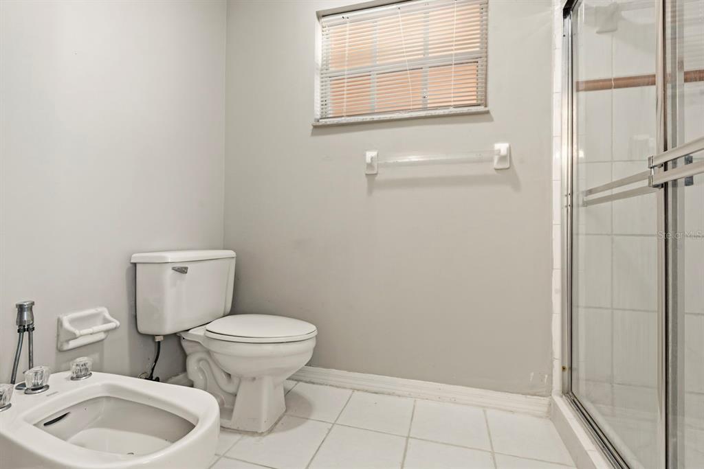 15313 Southwest 138th Terrace Miami, FL 33196 - Photo 25 of 44 a bathroom with a toilet sink and mirror