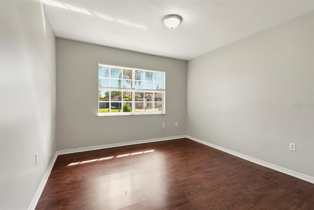 15313 Southwest 138th Terrace Miami, FL 33196 - Photo 26 of 44 an empty room with wooden floor and windows