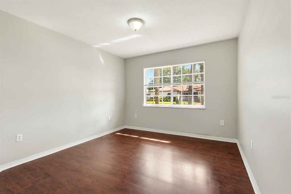 15313 Southwest 138th Terrace Miami, FL 33196 - Photo 28 of 44 an empty room with wooden floor and windows