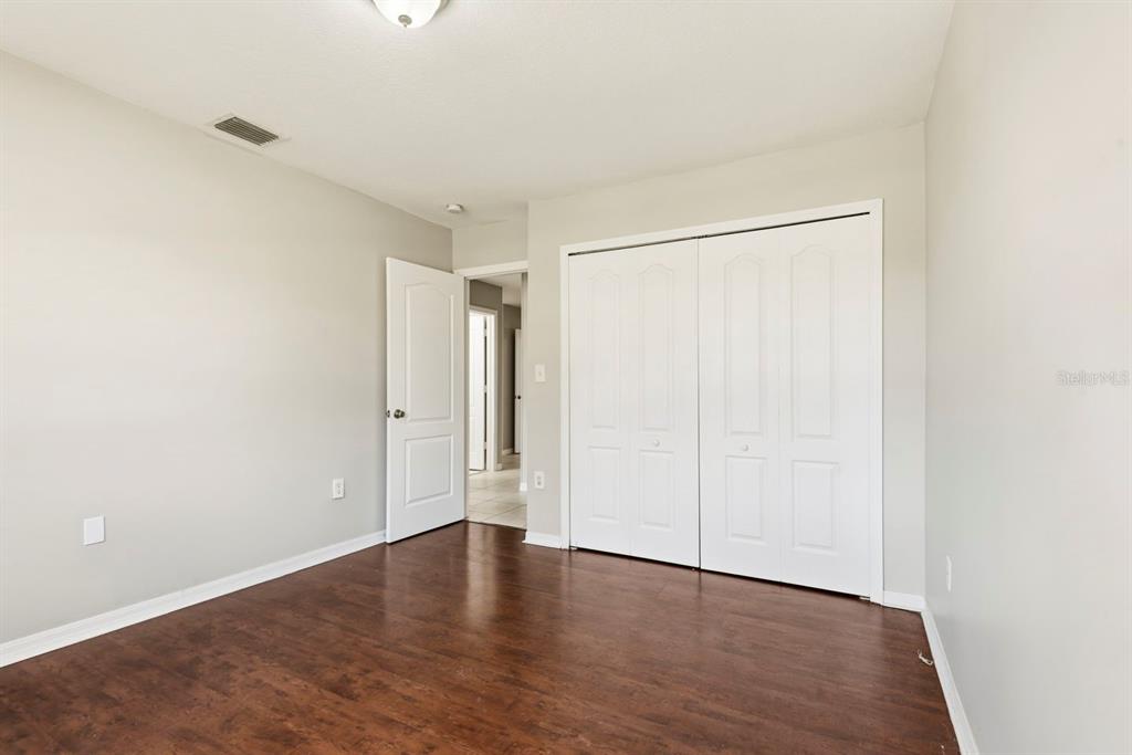 15313 Southwest 138th Terrace Miami, FL 33196 - Photo 29 of 44 a view of an empty room with wooden floor