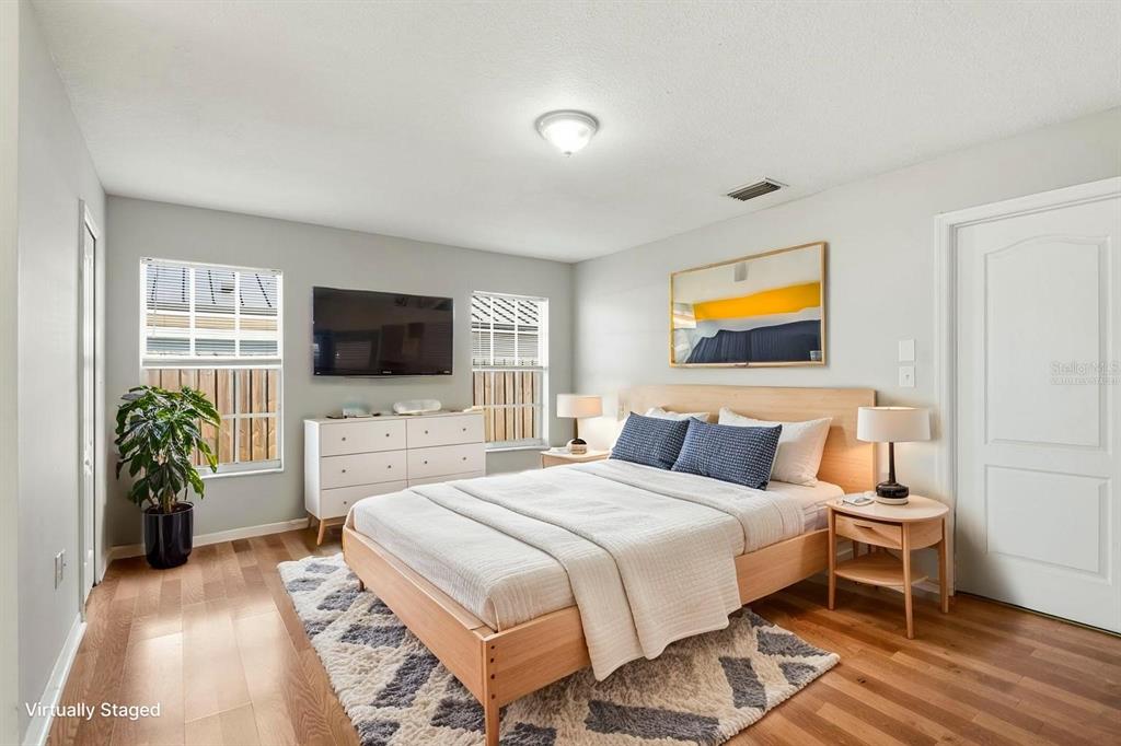 15313 Southwest 138th Terrace Miami, FL 33196 - Photo 3 of 44 a bedroom with a bed and a flat screen tv