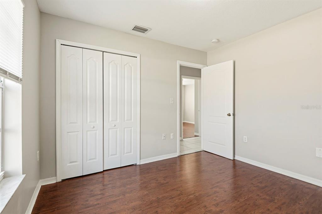 15313 Southwest 138th Terrace Miami, FL 33196 - Photo 31 of 44 a view of an empty room with wooden floor