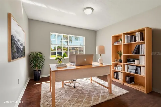 a workspace with furniture bookshelf and a window