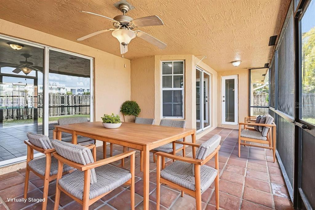 15313 Southwest 138th Terrace Miami, FL 33196 - Photo 6 of 44 a view of a dining room with furniture large windows and wooden floor