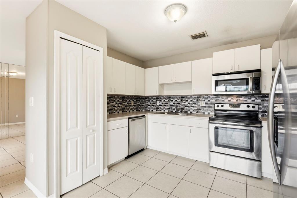 15313 Southwest 138th Terrace Miami, FL 33196 - Photo 8 of 44 a kitchen with granite countertop white cabinets and stainless steel appliances