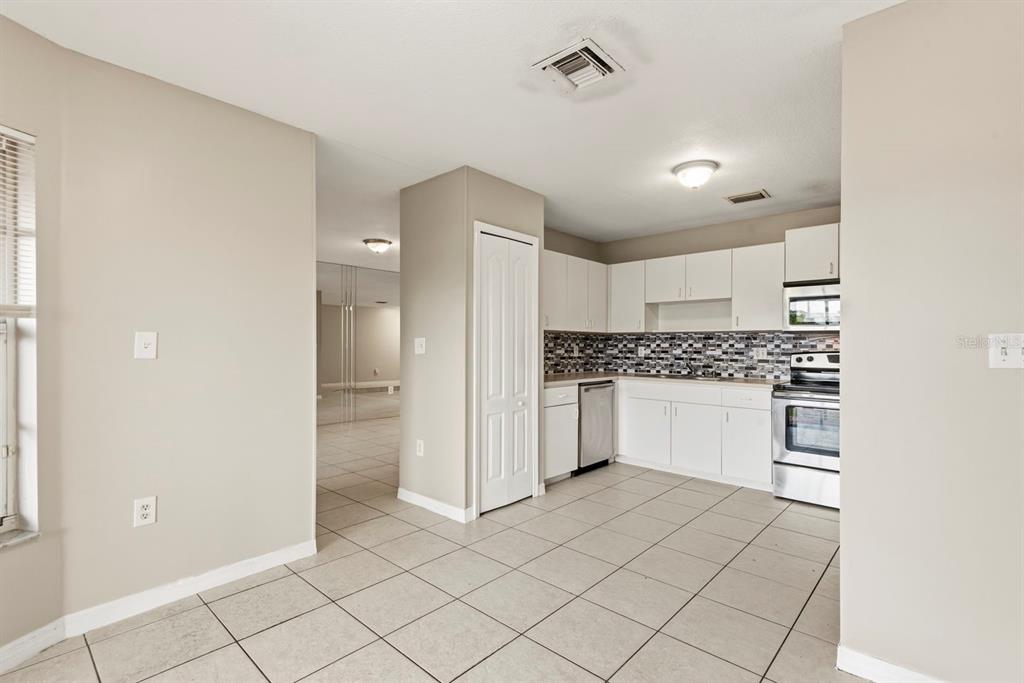 15313 Southwest 138th Terrace Miami, FL 33196 - Photo 10 of 44 a kitchen with white cabinets and white appliances