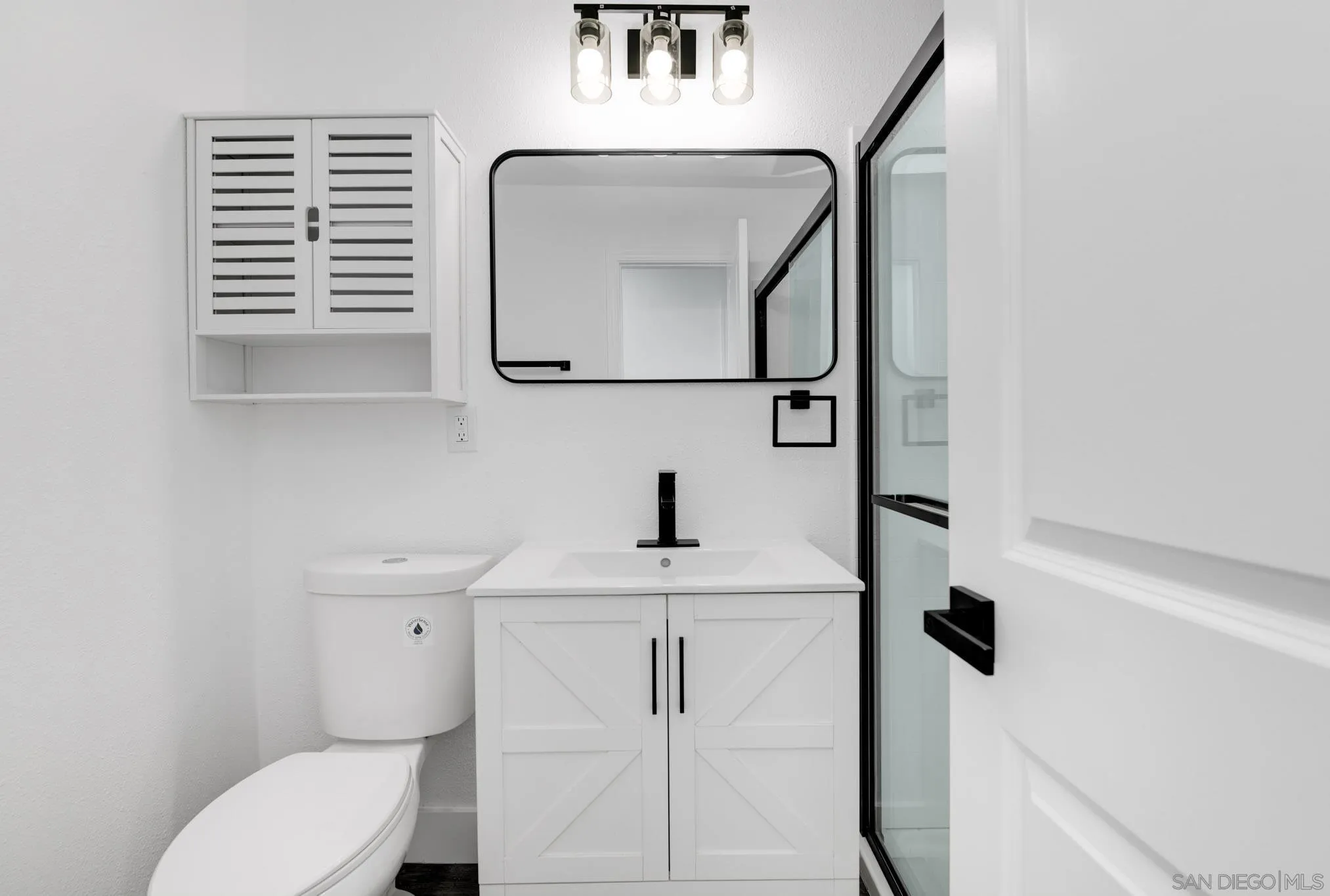 9125 Akard Street Spring Valley, CA 91977 - Photo 20 of 25 a bathroom with a toilet a sink and mirror