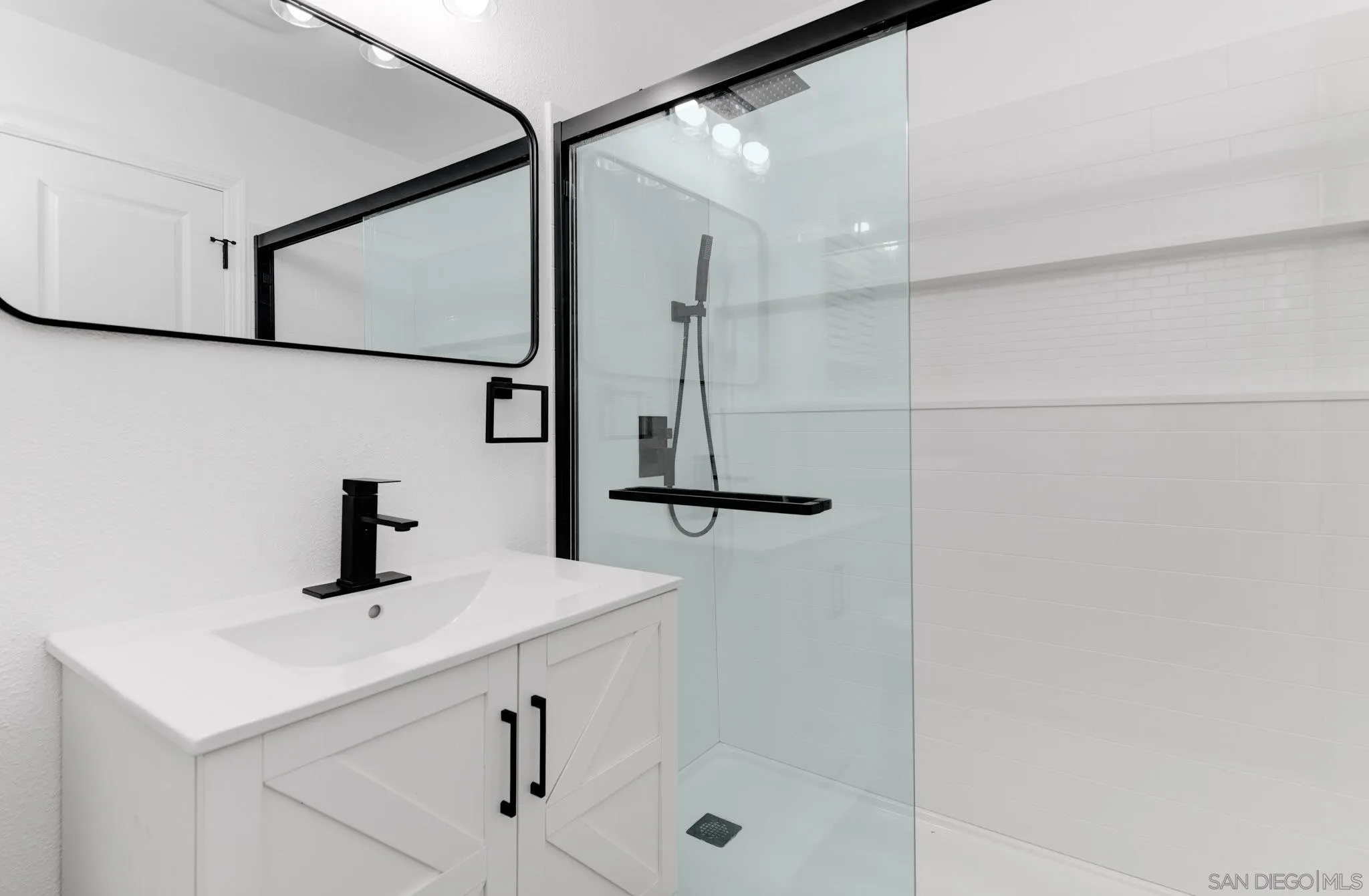 9125 Akard Street Spring Valley, CA 91977 - Photo 21 of 25 a bathroom with a sink and mirror