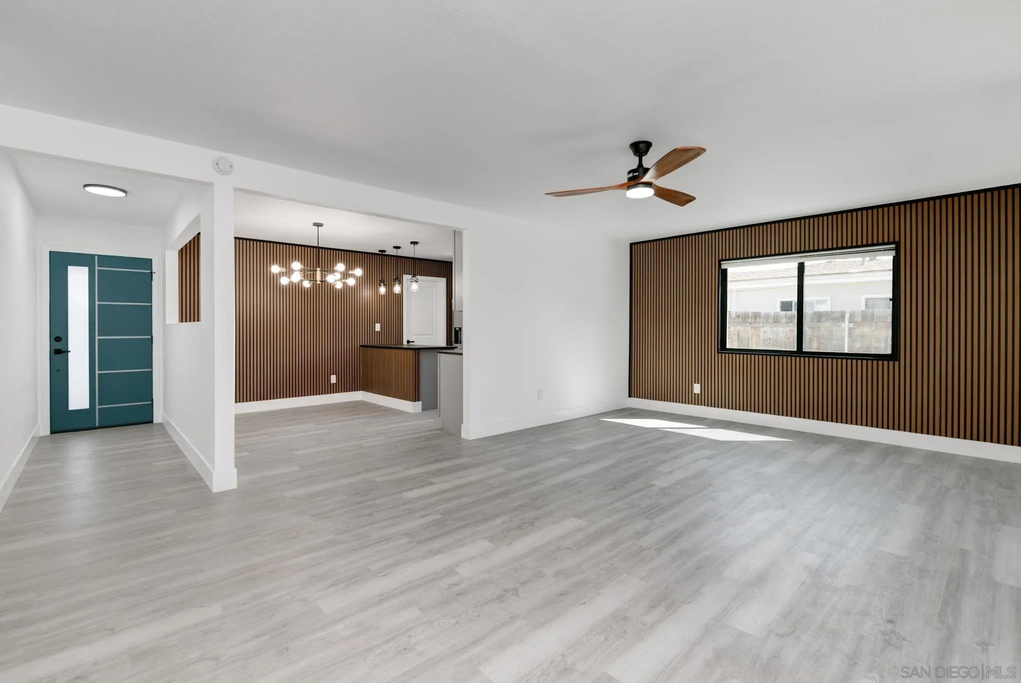9125 Akard Street Spring Valley, CA 91977 - Photo 3 of 25 a view of an empty room with window and wooden floor