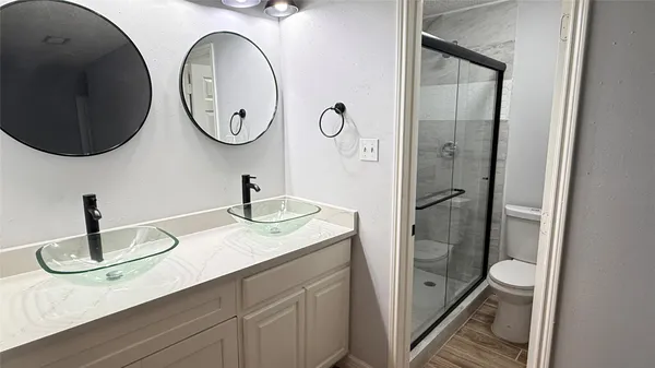 a bathroom with sinks and a mirror
