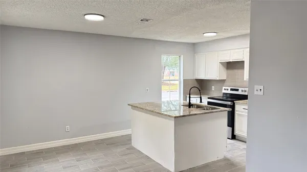 a kitchen with a sink cabinets and window