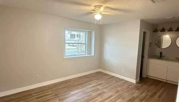 wooden floor in an empty room with a window