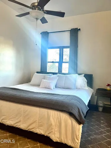 a bedroom with a bed and window