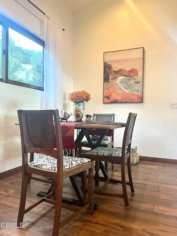 a view of a dining room with furniture window and wooden floor