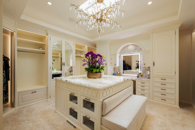 a kitchen with stainless steel appliances kitchen island granite countertop a table and chairs in it