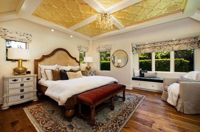 a bed room with a bed a mirror and a window