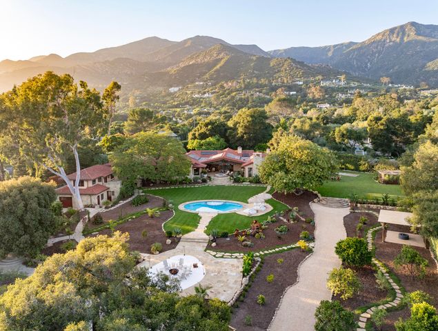 an aerial view of residential house with parking space and city view