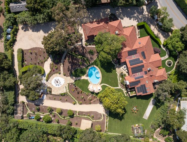 an aerial view of residential house with outdoor space and swimming pool