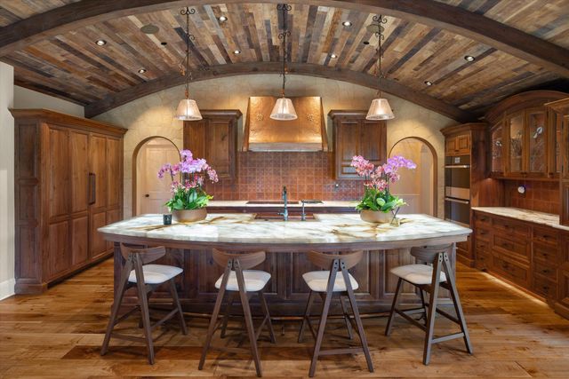 a view of a dining room with furniture and chandelier