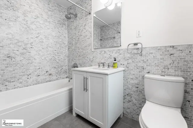 a bathroom with a sink toilet and bathtub