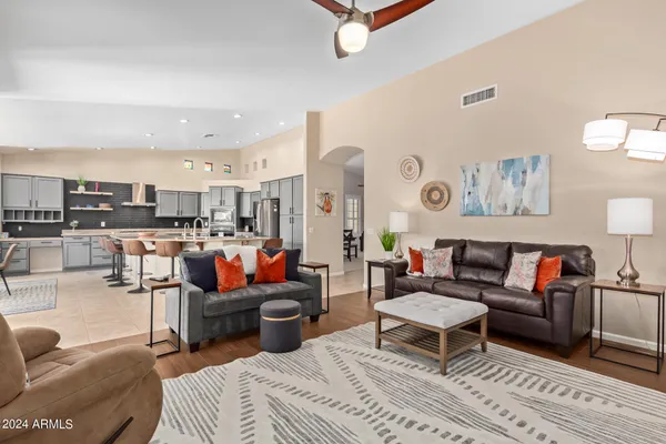 a living room with furniture kitchen view and a table