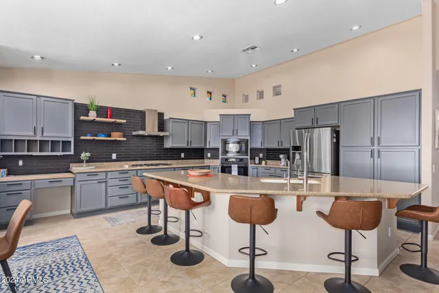 a kitchen with stainless steel appliances kitchen island granite countertop a sink and cabinets