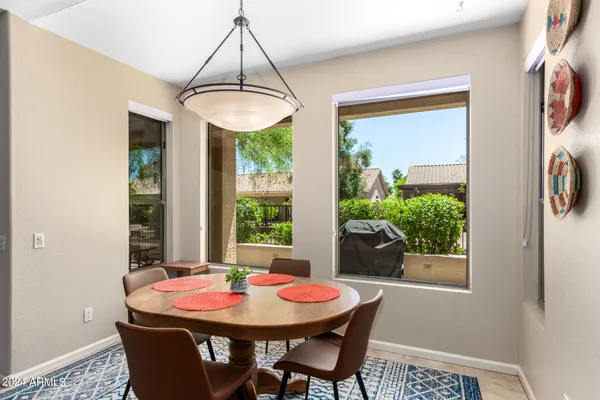 a dining room with furniture a chandelier and window