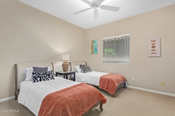 a bedroom with two beds and a window