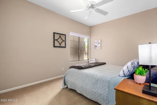 a bedroom with a bed and a potted plant