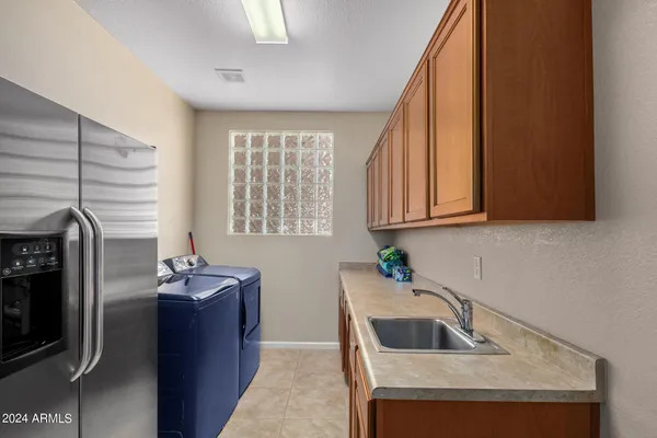 a kitchen with granite countertop a sink and a refrigerator