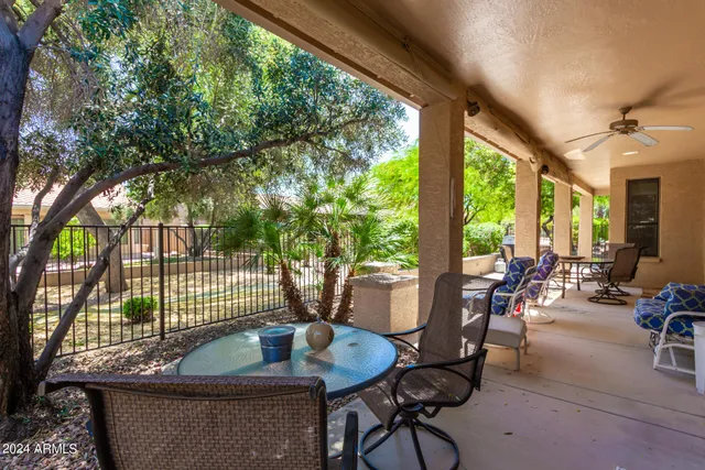 a living room with patio furniture and a potted plants