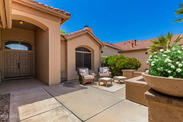 a view of a patio with couches and potted plants