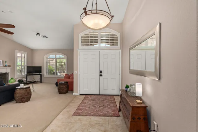 a very nice looking room with many windows and furniture