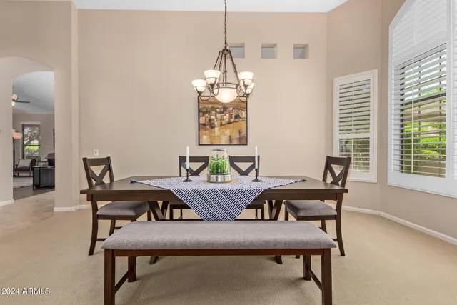 a view of a dining room with furniture and window