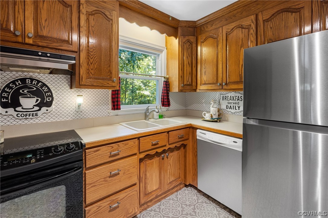 9505 Beach Road Chesterfield, VA 23838 - Photo 12 of 32 a kitchen with stainless steel appliances granite countertop a refrigerator a sink and wooden cabinets