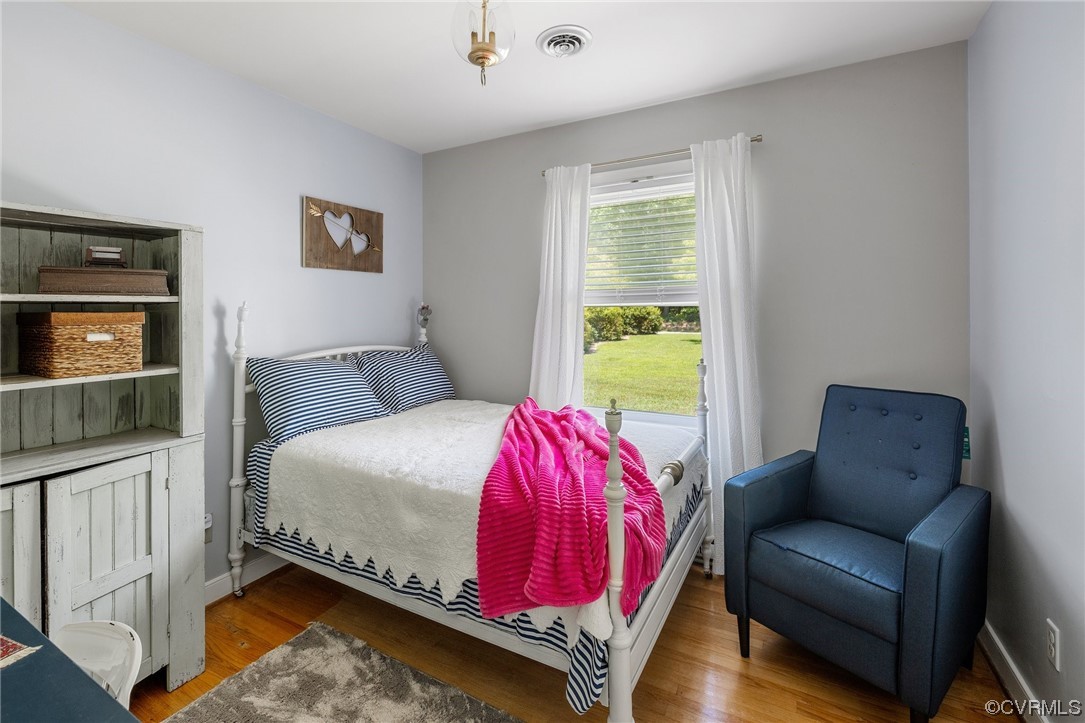 9505 Beach Road Chesterfield, VA 23838 - Photo 17 of 32 a bed sitting in a bedroom next to a window