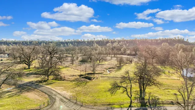an aerial view of residential houses with city view