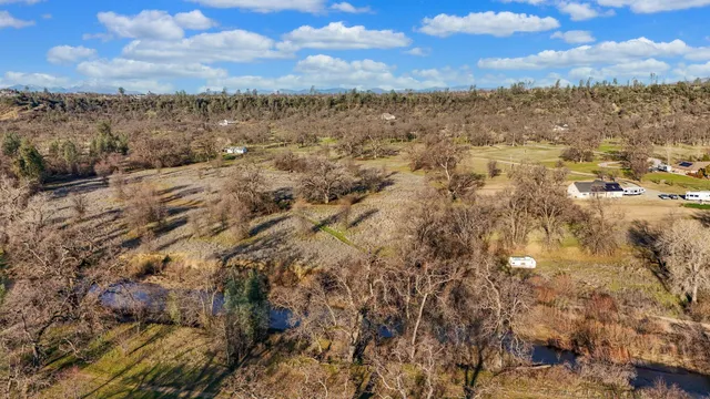 an aerial view of a houses with yard