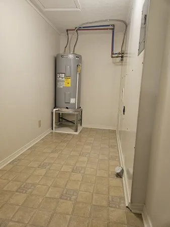 a view of storage and utility room with closet area